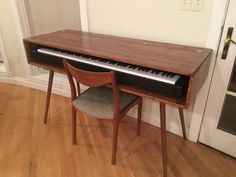 a piano and chair sitting in front of a door