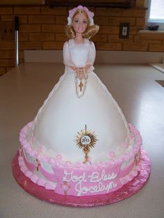 there is a barbie doll cake on the table