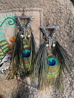 Rain forest witch theme jewelry, copper details, Jasper stone beads, Peacock Feathers, boho style jewelry, earrings, pagan jewelry, tribal jewelry, summer attribute. The feathers were collected without cruelty. Handmade Bohemian Copper Jewelry, Handmade Copper Bohemian Jewelry, Bohemian Metal Earrings With Peacock Design, Bohemian Wire Wrapped Earrings For Festivals, Bohemian Copper Dangle Jewelry, Bohemian Peacock Earrings As Gift, Bohemian Peacock Earrings For Gift, Peacock-colored Bohemian Earrings For Gift, Peacock Bohemian Earrings As Gift