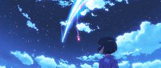 a person standing in front of a sky filled with clouds and stars, looking up at a shooting star