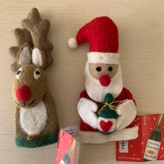 two stuffed animals are sitting next to each other on the wall with christmas decorations around them