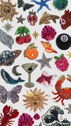 an assortment of different types of sequins and beads on a white background,