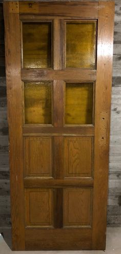 an old wooden door with glass inserts