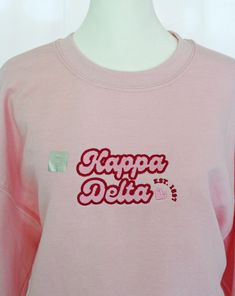 a pink sweatshirt with the words happy delta on it