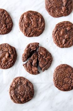 chocolate cookies are cut in half on a piece of parchment paper