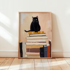 a black cat sitting on top of a pile of books in front of a white wall