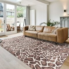 a living room with an animal print rug on the floor