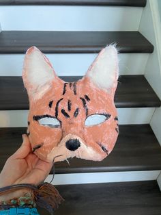 Hi and welcome to my shop! This beautiful serval cat mask is purrfect for anyone wanting a nice and cozy mask! This mask comes without fake eyes, but you can add them on or wear it without! The mask features tall ears, like on a serval, with lots of faux fur inside. The mask shows off the beauty of the serval with its stripes. Please check all photos, as this is ooak and not perfect. Since the mask is fully lined, it's very comfortable! Thanks for supporting my small business! Message me with an Cat Ears Masks With Whiskers For Masquerade, Masquerade Cat Ears Mask With Whiskers, Halloween Cat Ears Mask With Whiskers, Halloween Cat Design Masks And Prosthetics With Cat Ears, Halloween Cat Design Masks With Cat Ears, Masquerade Masks With Cat Design And Cat Ears, Serval Cat, Serval Cats, Fake Eye