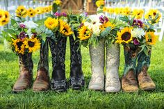 cowboy boots with sunflowers and daisies in them are lined up on the grass