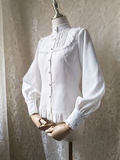 Features: It features stand collar, leg-of-mutton sleeves, ruffled cuffs, placket with seven buttons, flounce hem..Attention: This price includes a shirt only, others are not included. Size Chart:Size (CM): Unit CM; Sizes below are measured in flat-laid position, hand measurement will have discrepancy of about 2 CM.Size(cm)XSSMLXLXXLShoulders353637383940Bust8286909498102Waist667074788286Sleeves Length575859606162Shirt Length565758596061 Classic Fitted Blouse With Pearl Buttons, Elegant Blouse With Peter Pan Collar And Buttons, Fitted Button-up Blouse With Lace Cuffs, Elegant Stand Collar Top With Buttons, Elegant Tops With Stand Collar And Button Cuffs, Elegant Tops With Button Cuffs And Stand Collar, Elegant Stand Collar Blouse With Buttons, Elegant Blouse With Doll Collar, White Stand Collar Blouse With Buttons