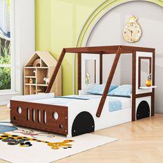 a child's bed with a wooden frame and slide on the bottom, in a room with green walls