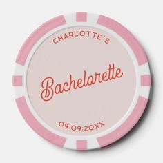 a pink and white poker chip with the name charlotte's bachelor written on it