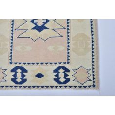 an old rug with blue and white designs on it's border, in the shape of a square