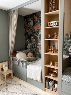 a child's bedroom with green walls and floral wallpaper