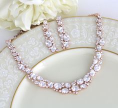 "This gorgeous Rose gold bridal jewelry set features dozens of oval and round CZ gemstones. This sparkling accessory is perfect for your wedding day! Size: Necklace: Length: 16'' and extends to 18\", Earrings: Length: 2'' You can choose a backdrop for this piece as well, please choose from the drop down menu. Matching bracelet: https://www.etsy.com/listing/265281912/rose-gold-bracelet-crystal-bridal Statement backdrop: https://www.etsy.com/listing/272743856/rose-gold-backdrop-necklace-bridal-bac Dazzling Rose Gold Jewelry Sets For Wedding, Rose Gold Round Jewelry Sets For Weddings, Rose Gold Cubic Zirconia Bridal Necklace For Anniversary, Dazzling Rose Gold Bridal Necklace For Formal Occasions, Gold Oval Jewelry Set For Wedding, Oval Gold Jewelry Set For Wedding, Rose Gold Bridal Jewelry Set, Rose Gold Necklace Set, Gold Bridal Jewelry