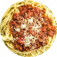 spaghetti with meat sauce and parmesan cheese in a bowl on a white background