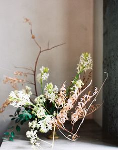 a vase filled with white flowers sitting on top of a table