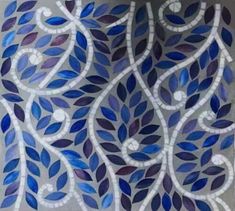 a painting with blue and purple leaves painted on the side of a wall in front of a window