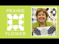 a woman holding up a piece of fabric with the words prairie flower in front of her