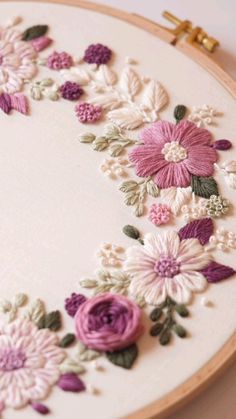 an embroidery project with flowers and leaves on it