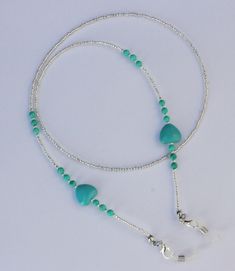 "Beautiful turquoise glasses chain spectacles holder. Made using turquoise gemstone beads and howlite hearts with clear glass seed beads and finished with rubber ends to attach your glasses. The chain measures approximately 28\" in length (If you would like a different length please leave a message on the order). Presented in an organza pouch. Lovely and useful gift idea." Handmade Adjustable Turquoise Glasses Chains, Adjustable Glass Jewelry With Heart Beads, Eye Glasses Holder, Glasses Chains, Organza Pouch, Mask Chain, Glasses Holder, Handmade Jewelry Tutorials, Eye Glass