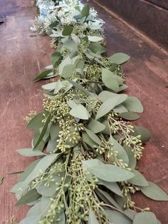 a long line of eucalyptus leaves and flowers