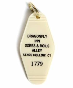 a keychain with the words dragonfly inn sores and boils alley stars hollow