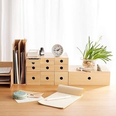 a wooden desk topped with lots of drawers and a clock on top of each drawer