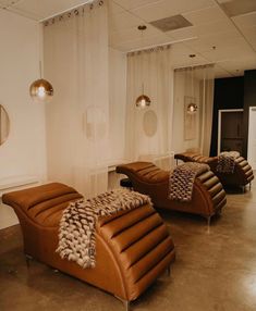 a living room filled with lots of furniture and decor on top of cement flooring