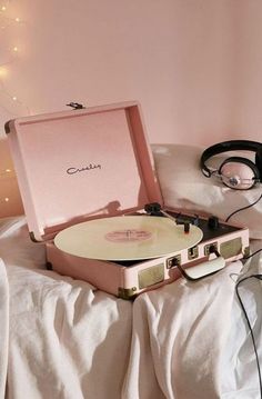 a record player sitting on top of a bed