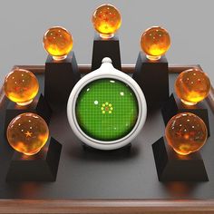 a green clock surrounded by orange balls on top of a wooden table with black bases