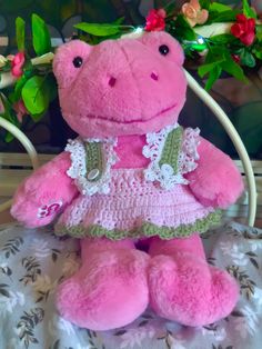 a pink stuffed animal wearing a dress