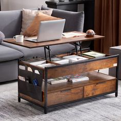 a living room with a couch, coffee table and laptop computer on top of it