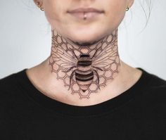 a woman with a tattoo on her neck has a bee and hexagon pattern