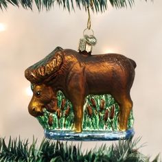 an ornament shaped like a cow hanging from a christmas tree