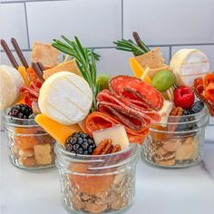 three glass jars filled with different types of food on top of a white marble counter