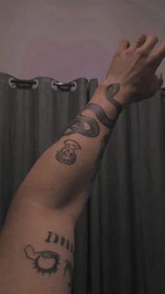 a person with tattoos on their arm and hand