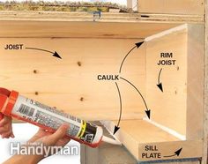 a man is holding a paint roller in his hand and painting the inside of a wooden box