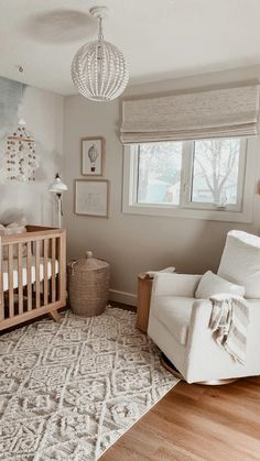 a baby's room with a crib, rocking chair, and large window