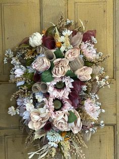 a bouquet of flowers hanging on the side of a door