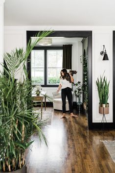 a woman is brushing her hair in the living room