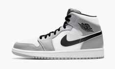 The Air Jordan 1 Mid “Light Smoke Grey” finds Michael Jordan’s first signature shoe in mid-top form in a shadowy, ultra versatile color scheme. The Jordan 1 Mid has gained popularity in sneaker culture for its unique mid-top shape and range of desirable colorways. Both aspects come into play on the “Light Smoke Grey” colorway. White leather forms the base of the upper, appearing on the perforated toe, mid-panel, and collar. Light Smoke Grey leather overlays can be found on the forefoot, eyelets, Air Jordan 1 Mid Grey, Sepatu Air Jordan, Retro Jordans, Buty Marki Nike, Zapatillas Nike Air, Vestiti Edgy, Grey Man, Grey Jordans, Boty Nike