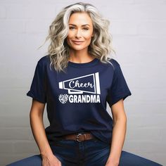 Proud cheer grandma shirt! Support your athlete in style. Our shop offers a little something for everyone, featuring the buttery soft Bella Canvas shirts, 100% cotton classic fit Gildan as well as Gildan Crewneck Sweatshirts. More details found below. 💙SIZE, COLOR & STYLE (for detailed sizing information, please see listing images) 🔵GILDAN SHIRT ➡ Gildan Heavy Cotton T-Shirt | Classic Fit Unisex Crew Neck  ➡Adult Shirt Sizes S-3XL | Youth Shirt Sizes YS-YL | Available in multiple colors ➡100% cotton - most colors | 90/10 blend - sport gray and antique heathers | 50/50 blend - safety colors and heathers 🔵BELLA+CANVAS SHIRT ➡Bella+Canvas T-Shirt | Soft and Comfortable Cotton | Classic Fit Unisex Crew Neck ➡Adult Shirt Sizes S-3XL | Available in multiple colors ➡100% Airlume combed and rin Cheer Grandma Shirt Ideas, Cotton Tops With Letter Print For Cheerleading, Team-colored Crew Neck T-shirt For Cheerleading, Graphic Cotton Tee For Cheerleading, Cotton Graphic Tee For Cheerleading, Cheer Grandma Shirts, Cute Crew Neck T-shirt For Cheerleading, Casual Crew Neck Sublimation T-shirt For Cheerleading, Cheer Grandma