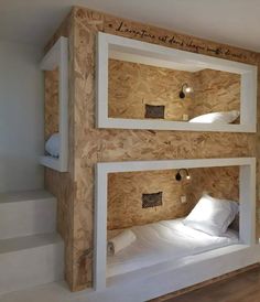 two bunk beds in a room with wooden walls