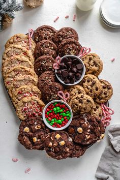 a platter filled with cookies, candy canes and candies on top of a table