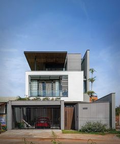 a car is parked in front of a modern house