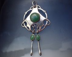 "STORY --------- Crafted in sterling silver, this striking Art Nouveau / Jugendstil style pendant holds three green chalcedony agate cabochons; two set in articulated drops. It remains in splendid vintage condition and can still be worn on a chain today... SPECIFICS -------------- Metal: Sterling silver (marked '925') Stones: Green chalcedony Dimensions: 49 x 27 mm Condition Notes & Care: Overall in expected vintage condition with minor wear. Ready for wear. SALES --------- > Please review all p Modern Jade Cabochon Jewelry, Modern Green Collectible Jewelry, Contemporary Green Sterling Silver Jewelry, Green Chalcedony, Art Nouveau Style, Antique Jewellery, Antique Collection, Antique Jewelry, Vintage Art