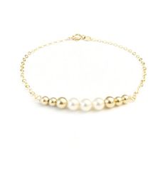 The perfect bracelet for everyday. This 14K gold filled bracelet is a contemporary update to the classic bead bracelet with a delicate row of gold filled beads and Swarovski cream pearls. Bracelet measures 6", 6.5", and 7" long. | The perfect bracelet for everyday. This 14K gold filled bracelet is a contemporary update to the classic bead bracelet with a delicate row of gold filled beads and Swarovski cream pearls. Bracelet measures 6", 6.5", and 7" long. | 1-800-Flowers Gifts Delivery 14K Gold Classic Gold Bracelets With Pearl Charm, Classic Gold Pearl Beaded Bracelets, Classic Gold Bracelet With Pearl Drop, Classic Everyday Pearl Bracelet With 14k Gold Filled, Classic 14k Gold Filled Pearl Bracelet For Everyday, Gold Pearl Bracelet With 14k Gold Chain, Classic 14k Gold Filled Pearl Bracelet, Classic Gold Pearl Bracelet For Everyday, Classic Everyday 14k Gold-filled Pearl Bracelet