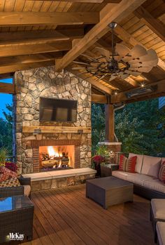 an outdoor living area with fireplace and seating