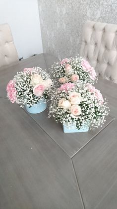 two blue vases filled with pink and white flowers